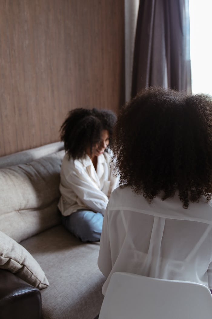 Counseling session with two women discussing mental health issues.